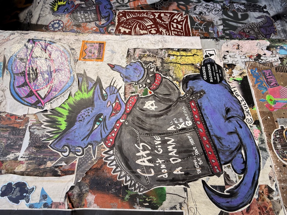 Street art cat character and graffiti wall